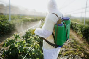 Agricultural worker appling pesticides